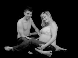 pregnant woman with her man in black and white
