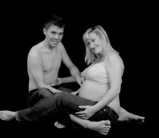 pregnant woman with her man in black and white
