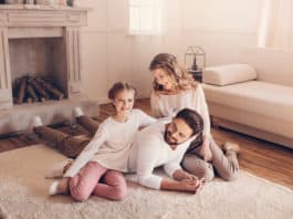 Happy young family with one child spending time together at home